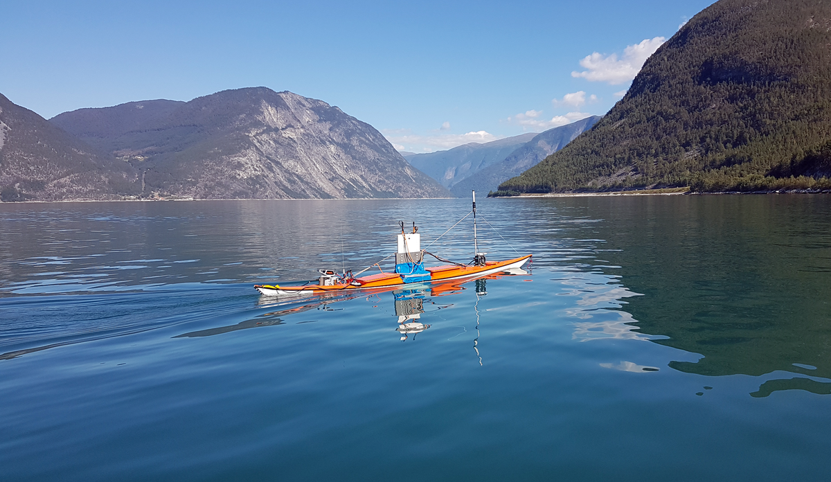 photo of an uncrewed kayak on the fjord